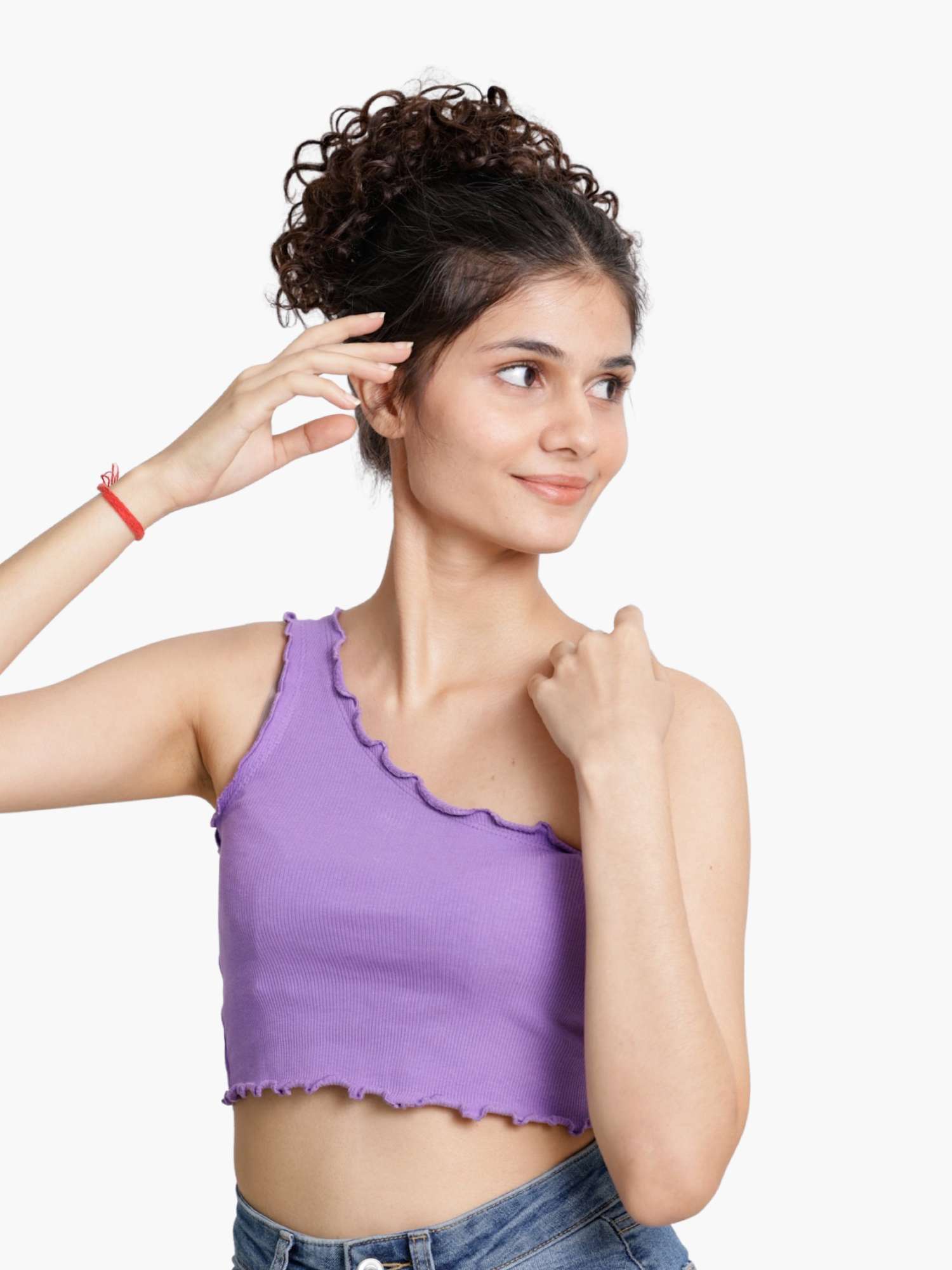 Model posing in side view after wearing a curly hair clip-in bun